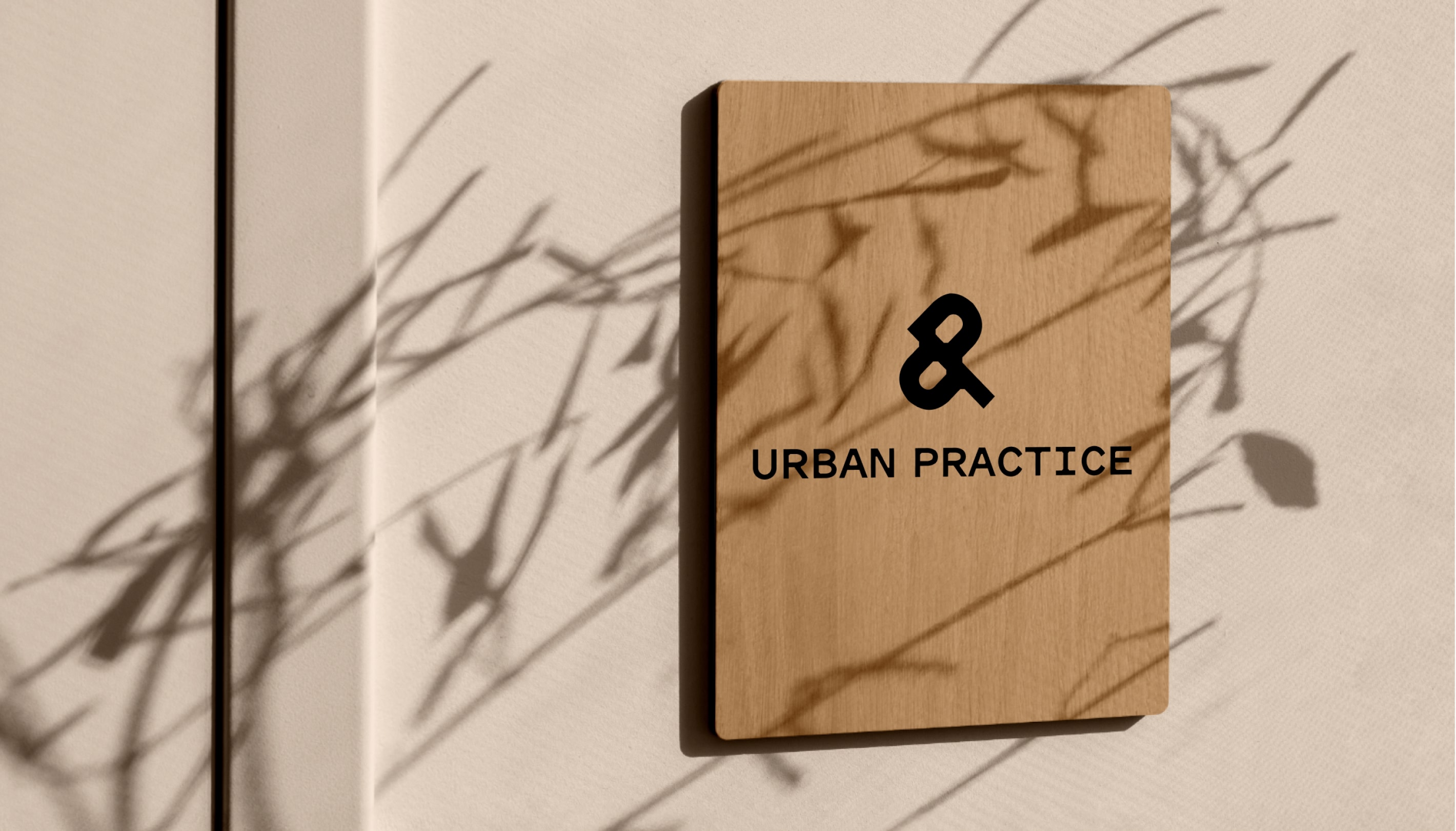 Urban Practice logo on a wooden sign