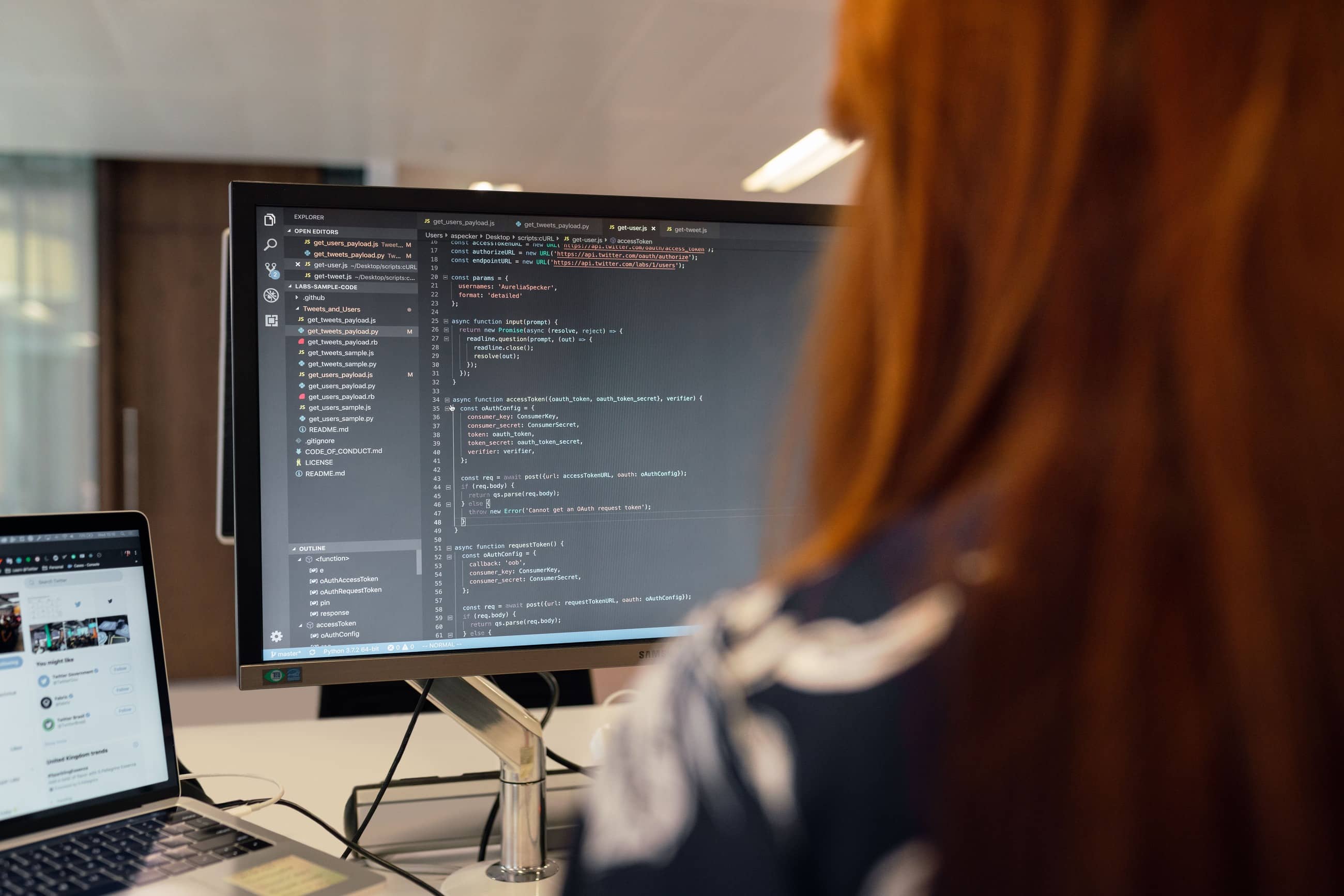Developer reviewing code on a large monitor
